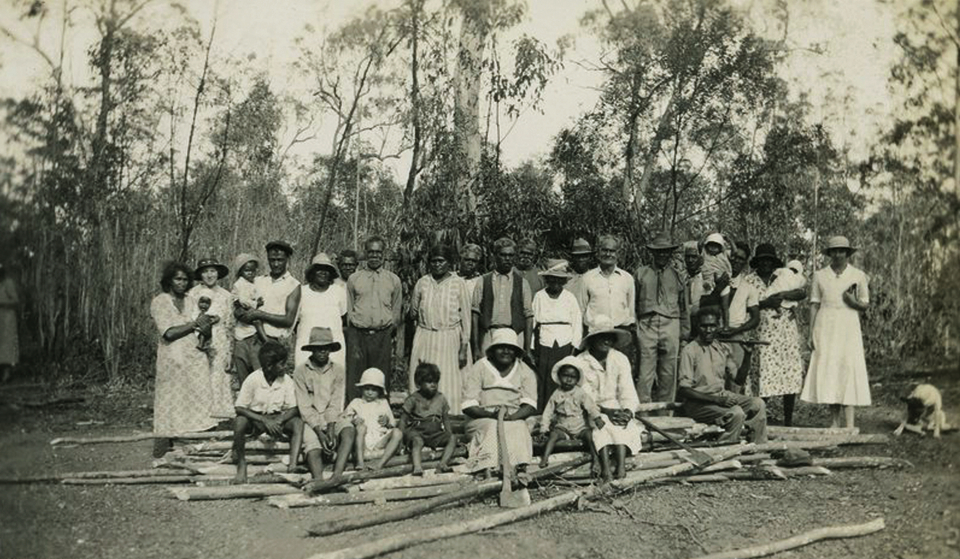 Group with wood for open-air cathedral at Barambah Aboriginal Settlement c1929