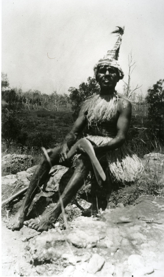 Man with boomerang at Barambah Aboriginal Settlement c1920