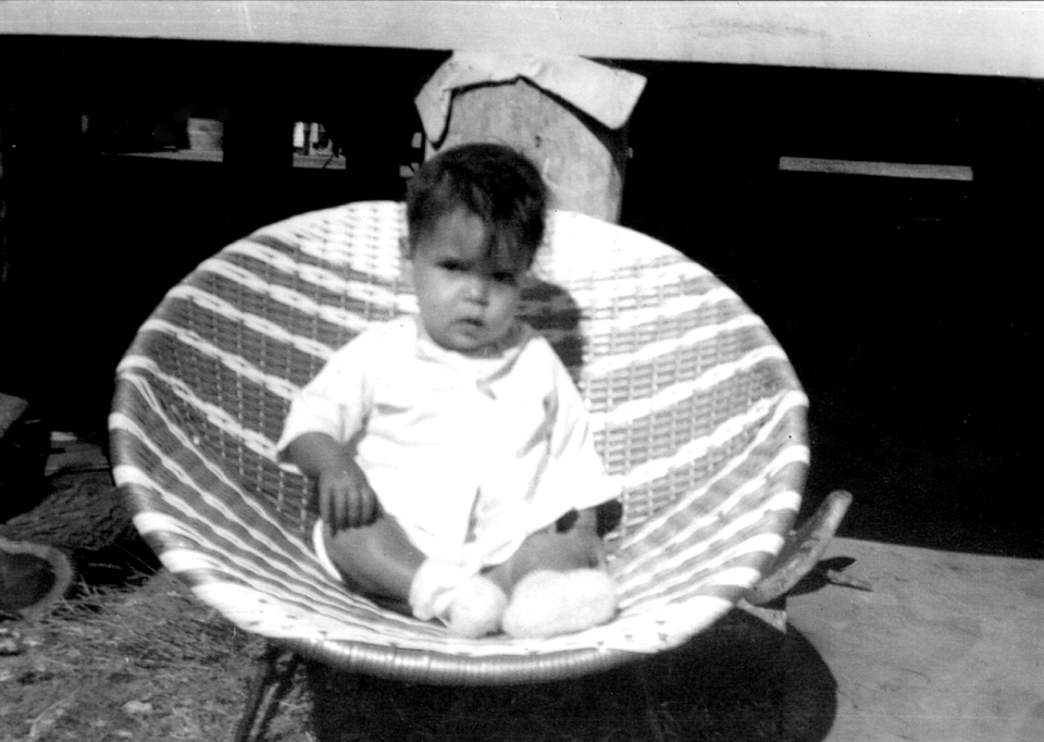 Child sitting in chair at Cherbourg Hospital c1961
