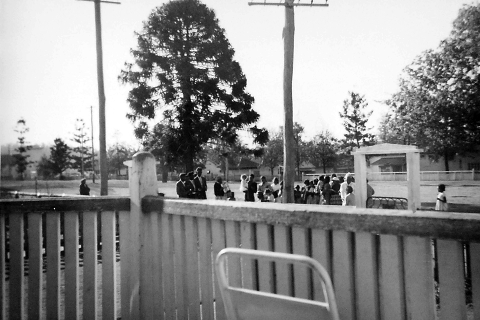 Church service outside hospital grounds at Cherbourg c1961
