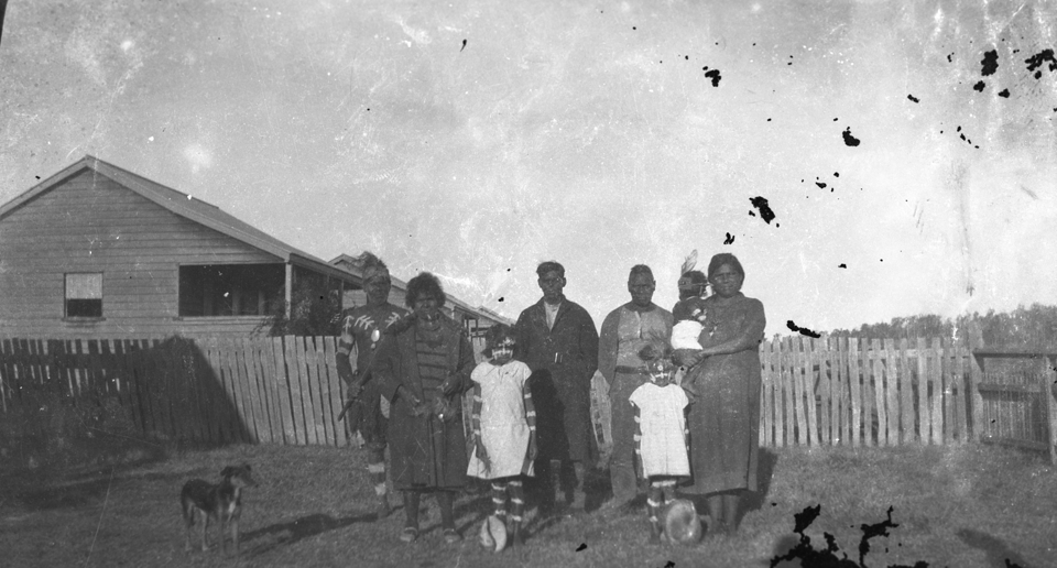 Family at front of cottages at Cherbourg 1934