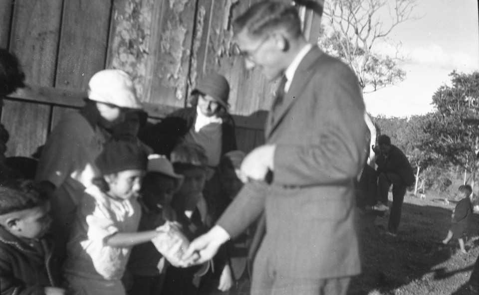 man-giving-children-lollies-at-cherbourg-aboriginal-settlement_1934