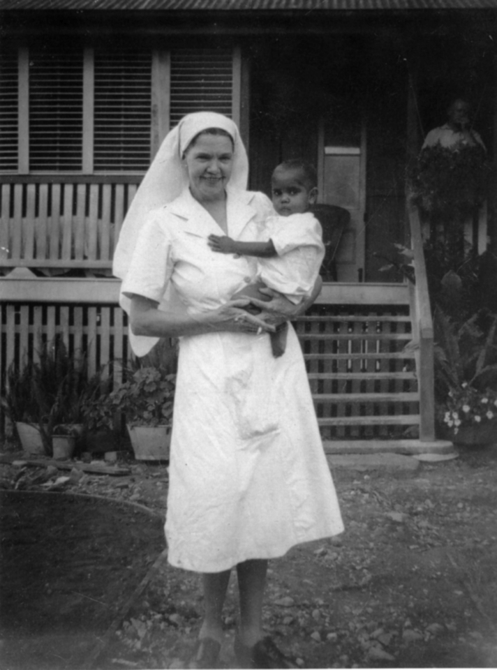 Nurse holding baby at Cherbourg c1962