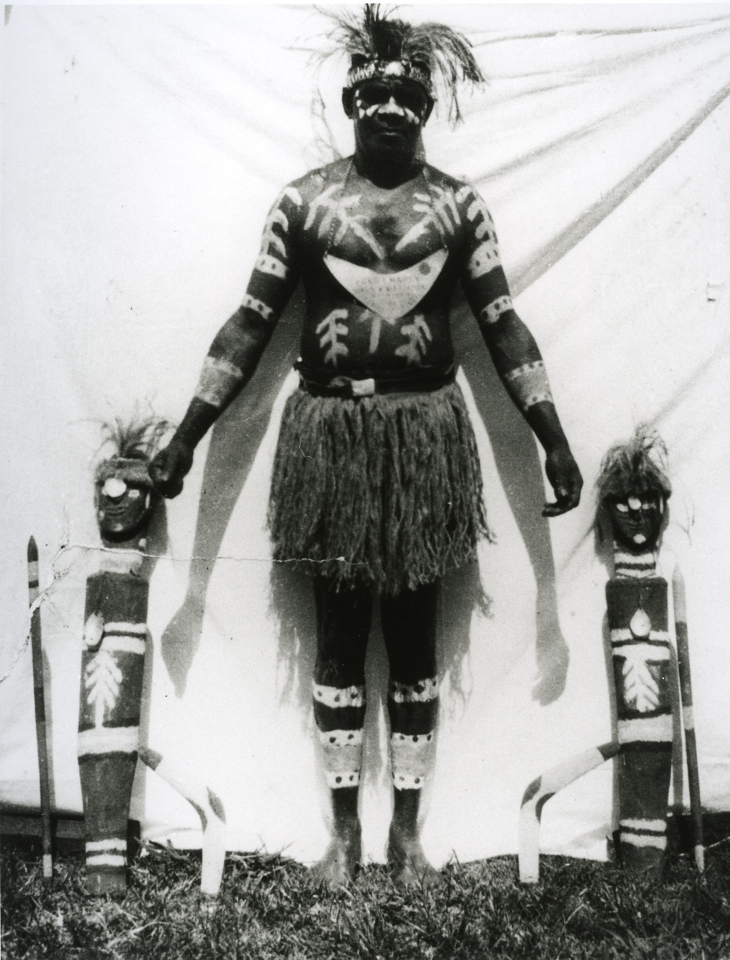 fred-embery-standing-with-objects-at-cherbourg-aboriginal-settlement_1930s