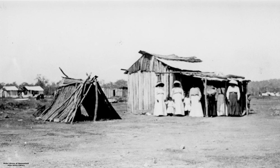 Group and huts at Barambah Aboriginal Settlement 1911